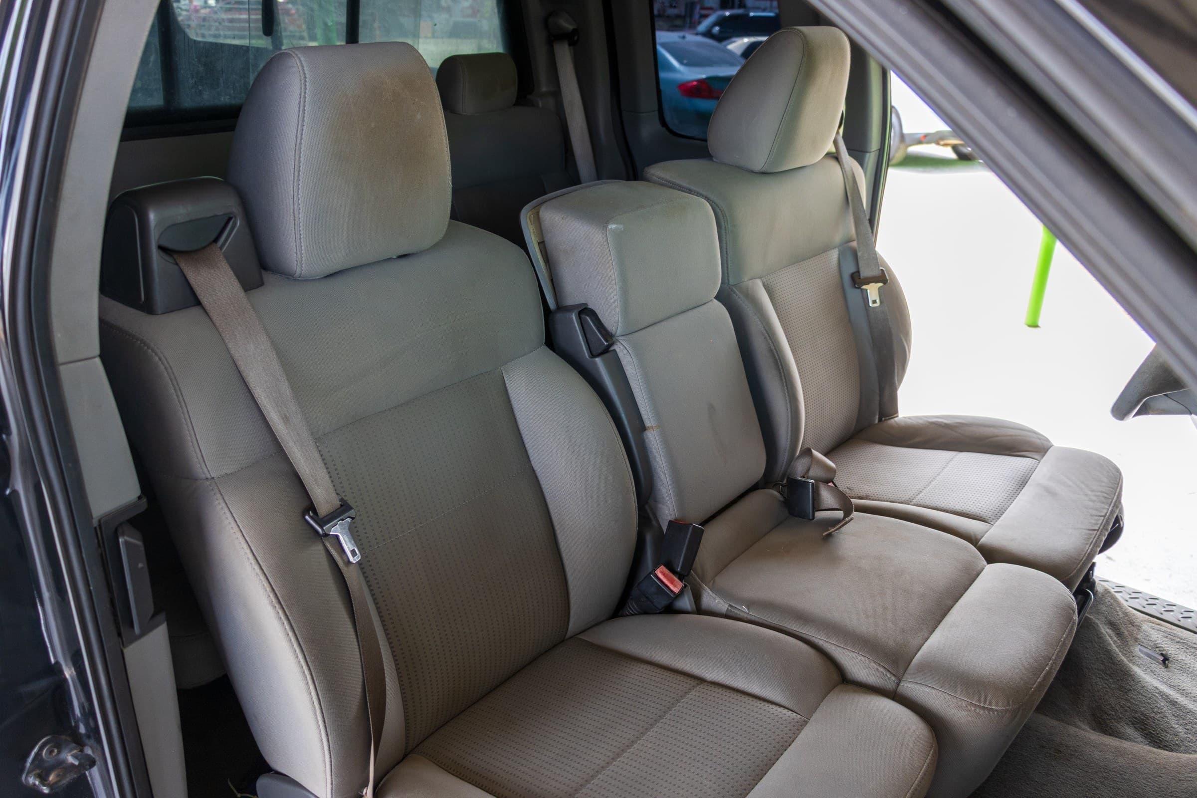 Rear seating area of the F-150 extended cab, with tan cloth seats and a fold-down rear bench.