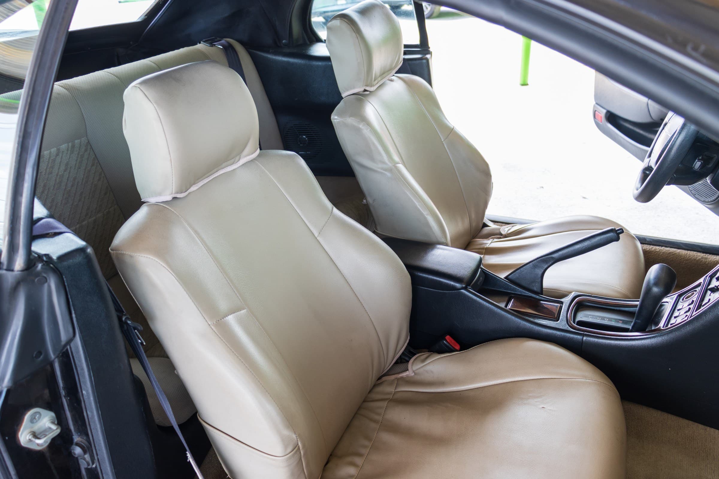 The Celica's tan leather front bucket seats and center console.