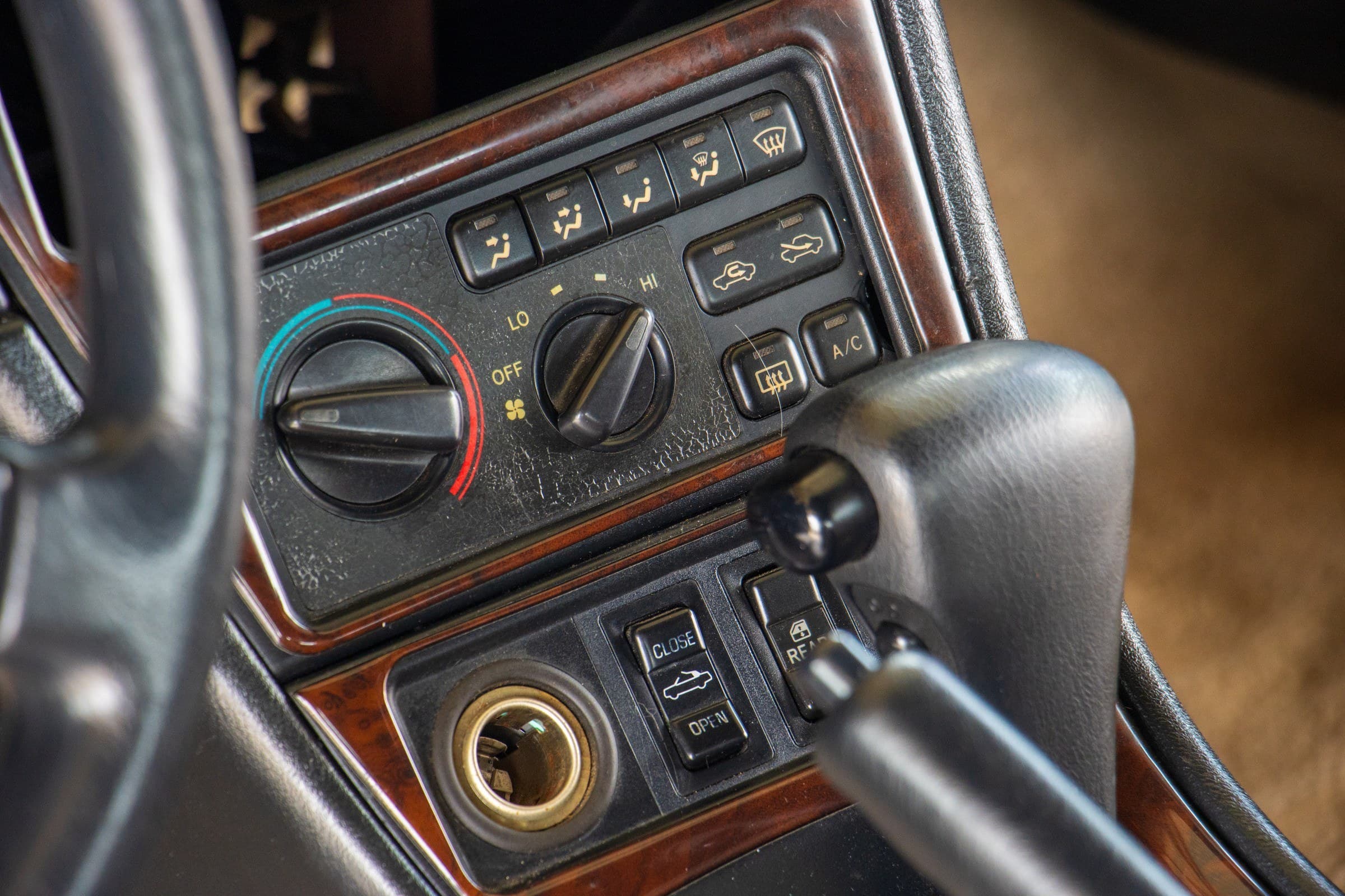 Close-up of the Celica's climate controls, with the power convertible-top open and close switch below.