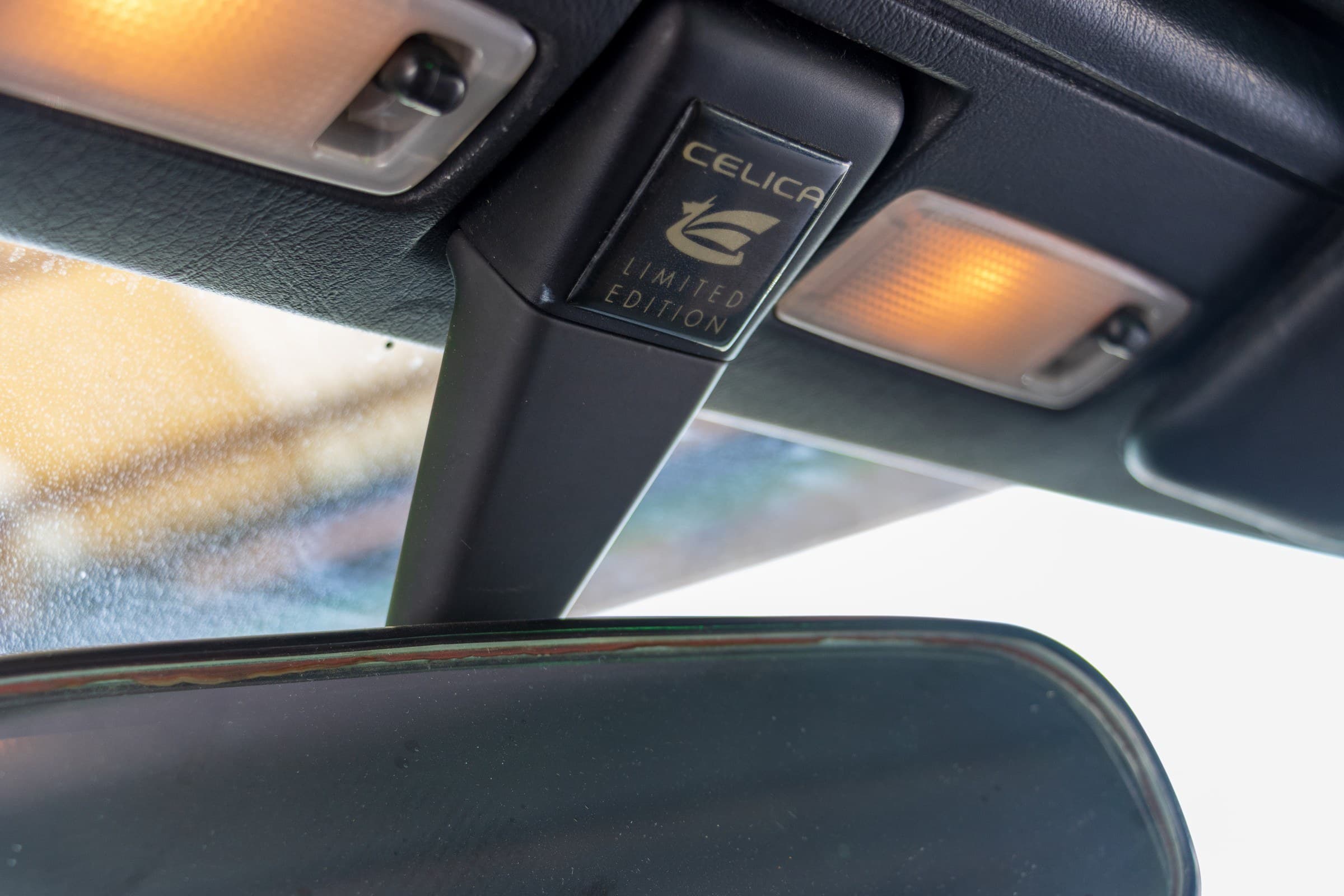 Celica Limited Edition plaque on the windshield header trim above the rear-view mirror.