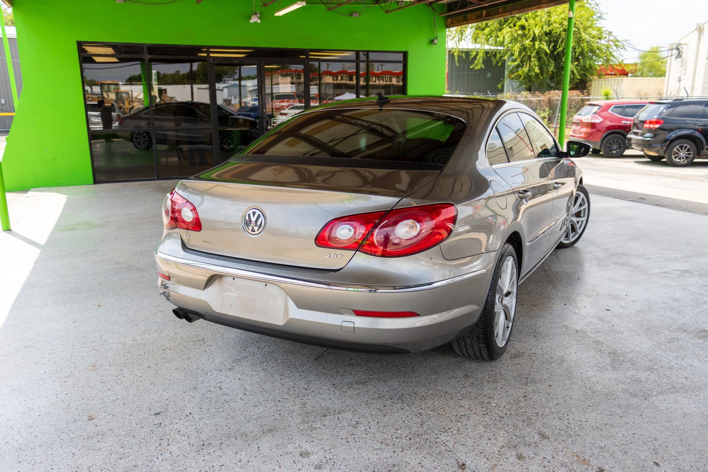 Rear three-quarter view of the Volkswagen CC, showing the CC and 2.0T badges and the chrome trim across the trunk.