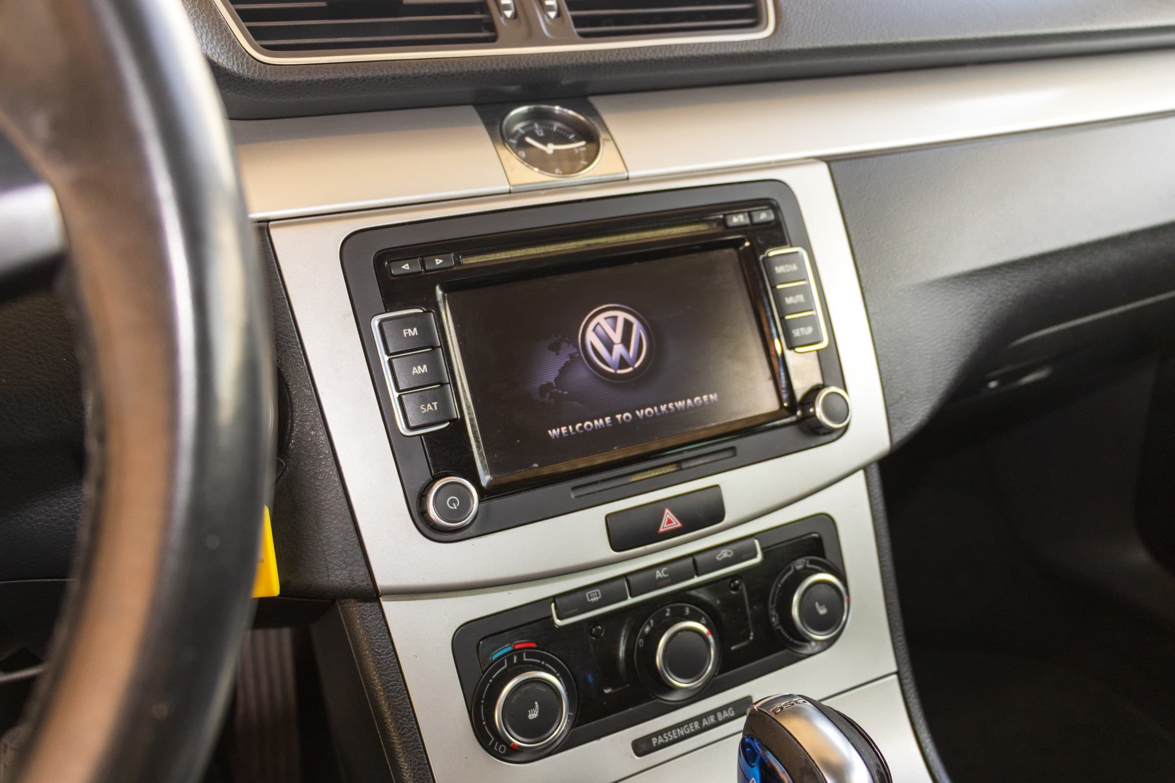 The CC's center stack, with the touchscreen radio, analog dash clock and the heated-seat and climate controls below.