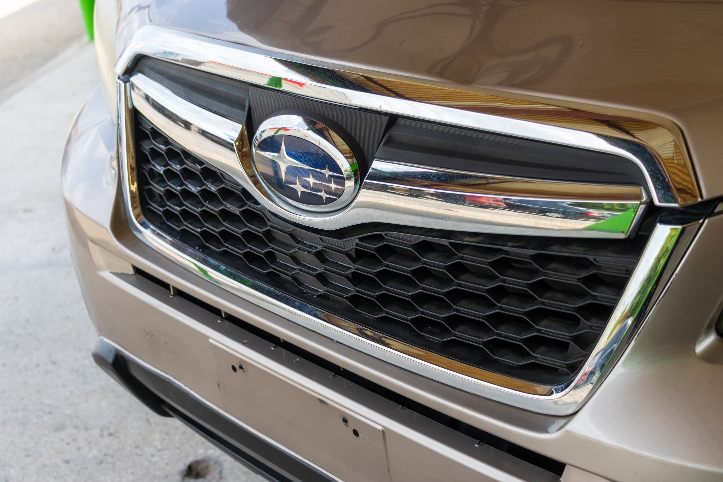 Close-up of the Forester's chrome grille bar and Subaru star badge.