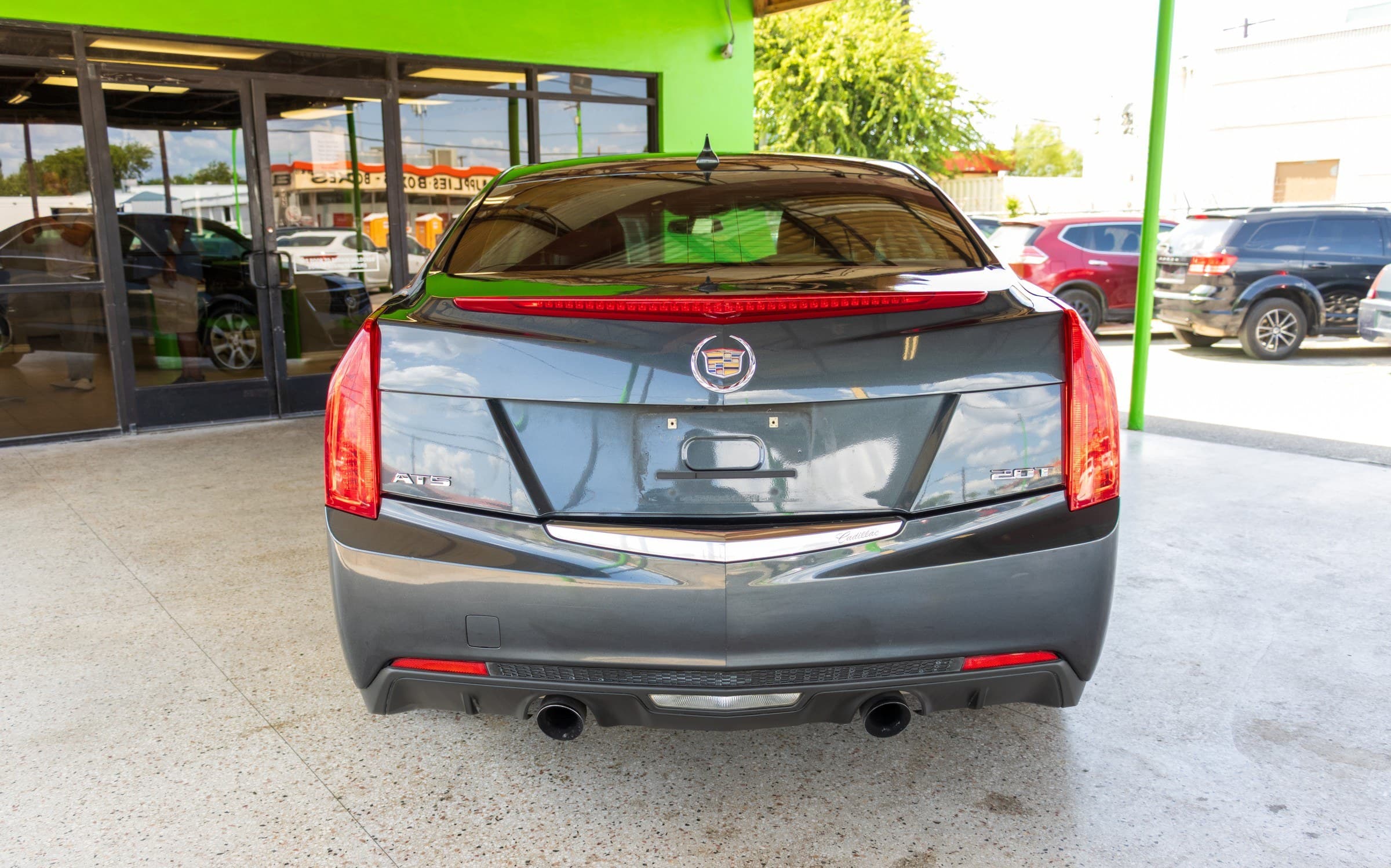 Rear view of the Cadillac ATS, showing the badging and dual exhaust outlets.