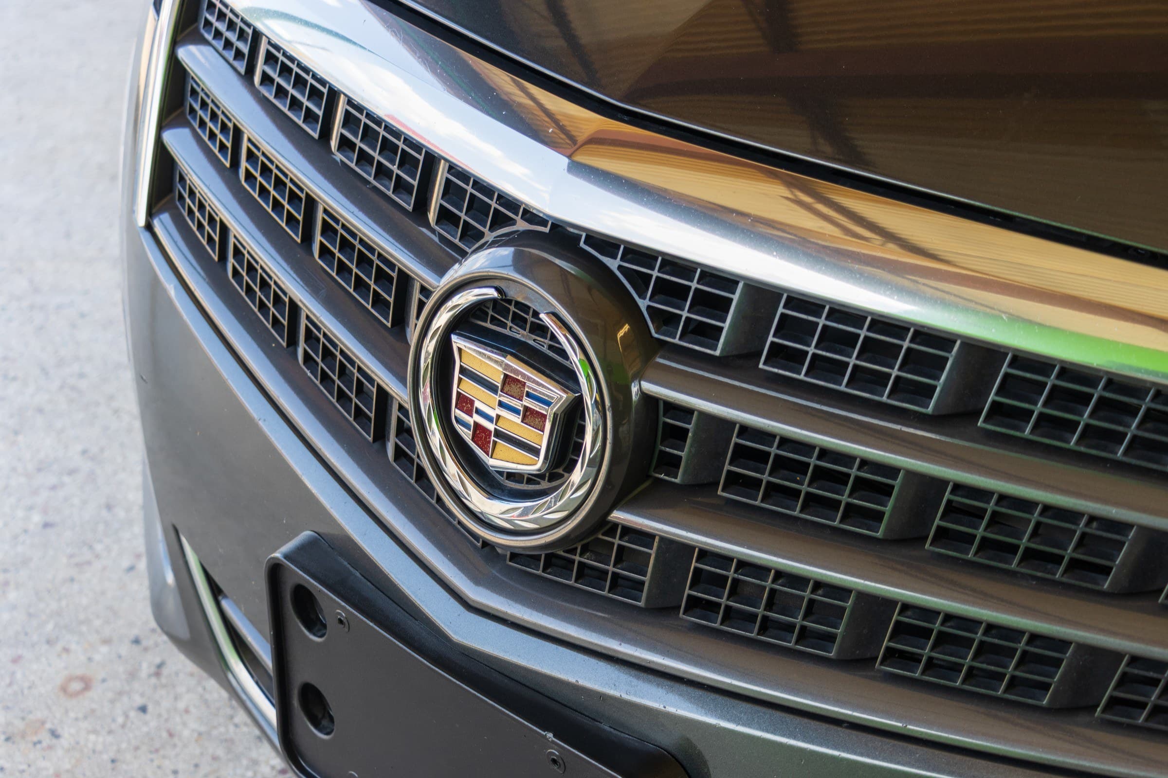 Close-up of the Cadillac ATS's chrome grille and the coloured Cadillac crest badge.